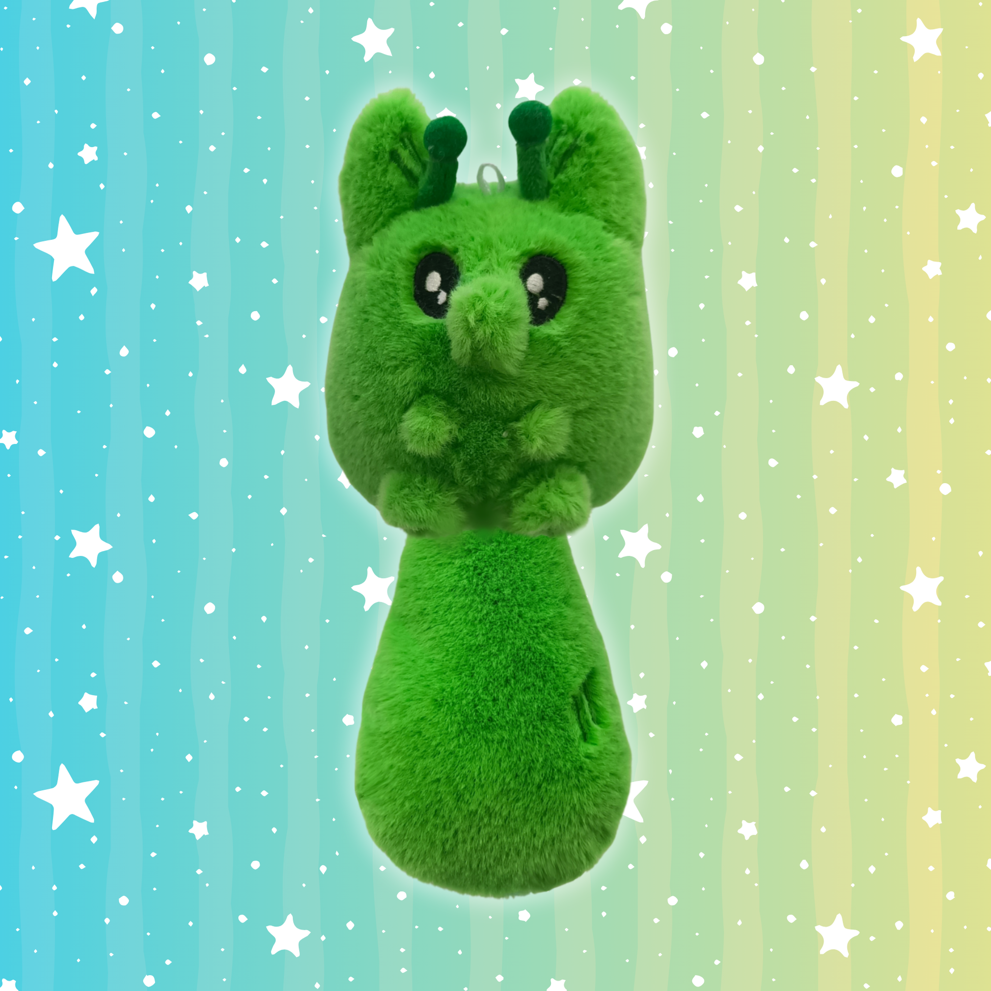 A green alien fox plush toy with two green antennas, little paws, and big eyes.