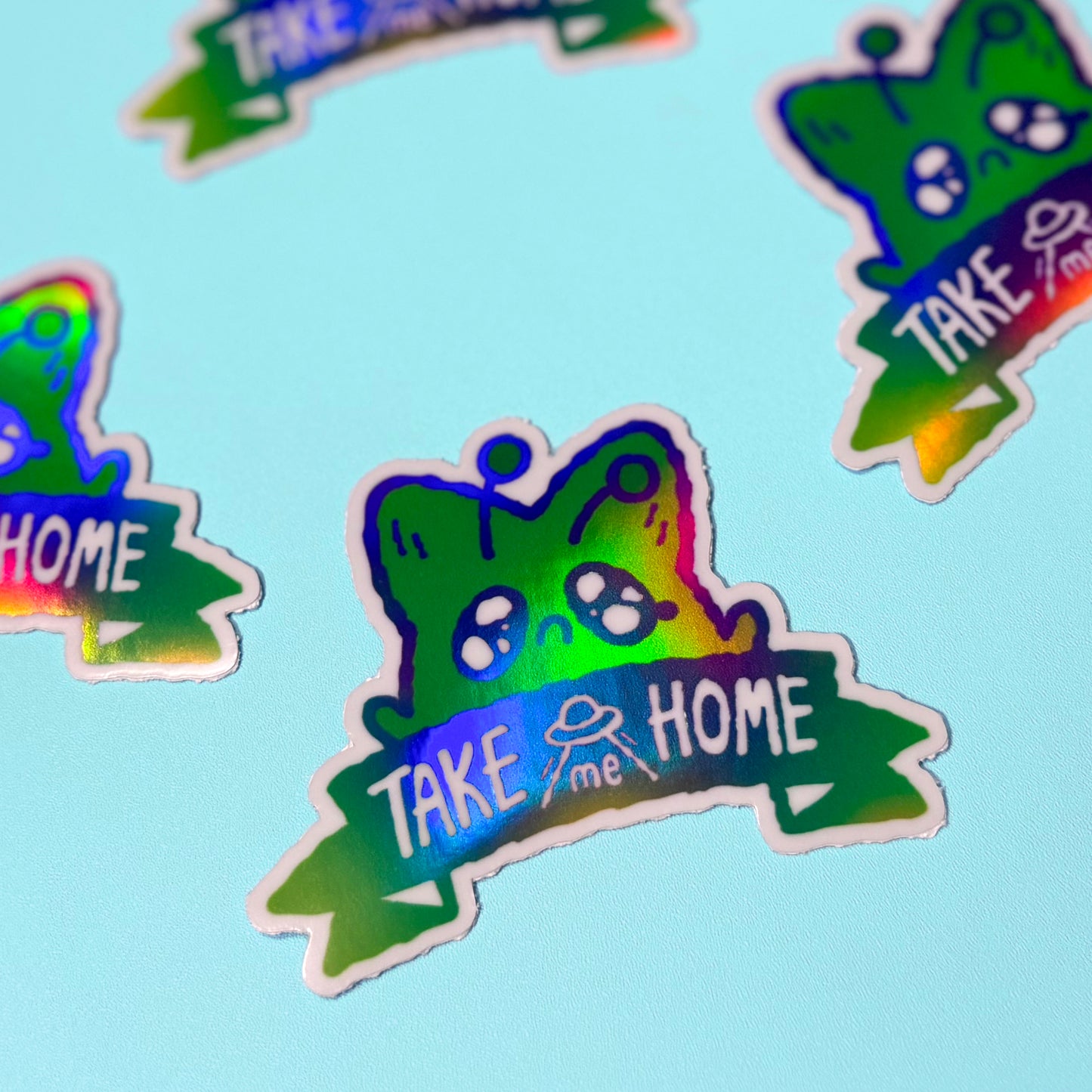 Colorful stickers with 'Take me Home' text on a light blue background