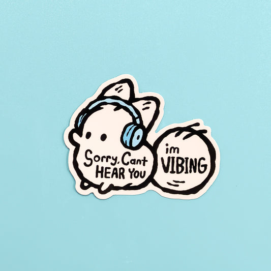 Sticker with a cartoon white fox wearing headphones and text on a light blue background