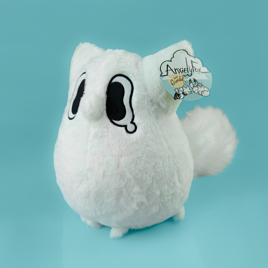 White plush toy of a fox with black accents on a light blue background