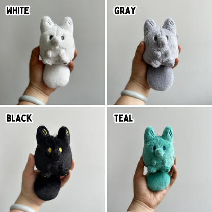Four panels with a hand holding a colorful fox plush toy against a white background