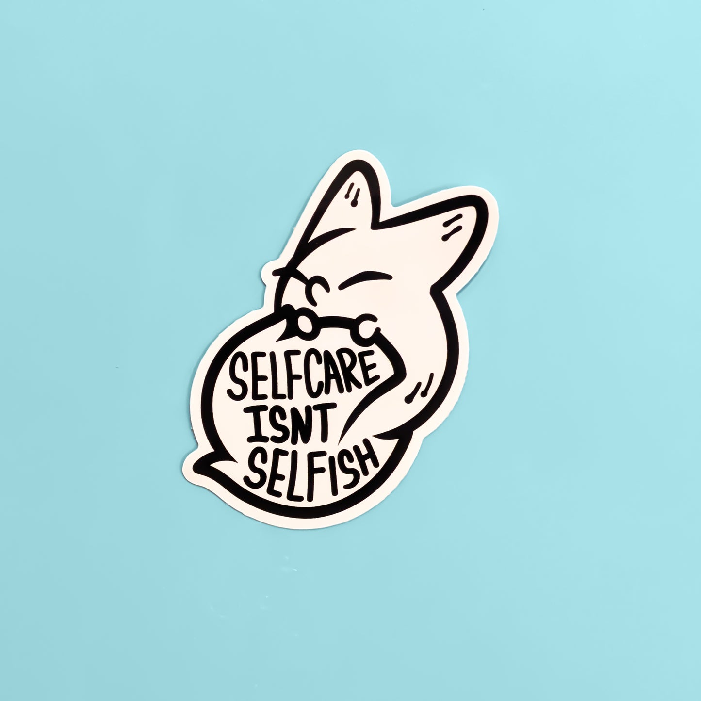 Sticker with a fox design and 'Self care Isn't Selfish' text on a light blue background