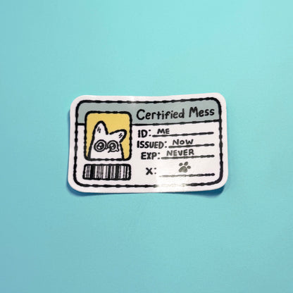 Sticker with 'Certified Mess' design on a light blue background