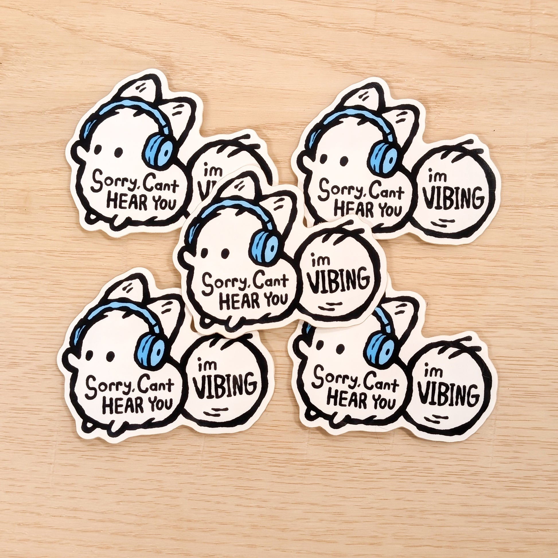 Set of stickers with cartoon white fox and text on a wooden surface