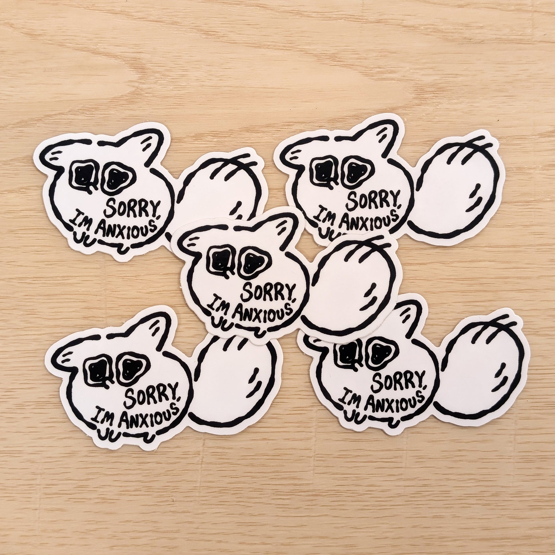 Stickers with 'Sorry, I'm Anxious' text on a wooden surface