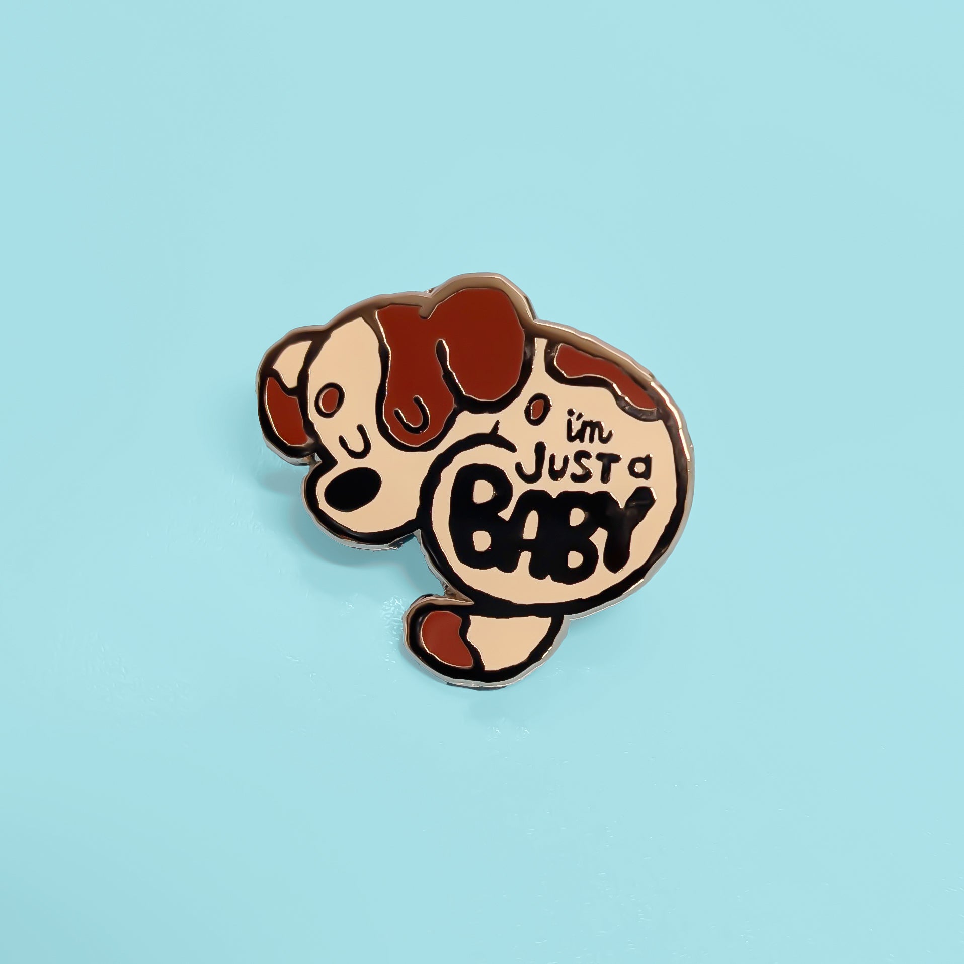Pin with cartoon dog design and 'I'm Just a Baby' text on a light blue background