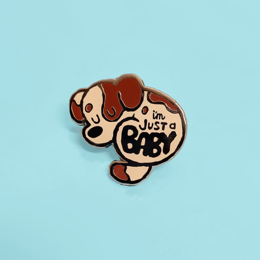 Pin with cartoon dog design and 'I'm Just a Baby' text on a light blue background