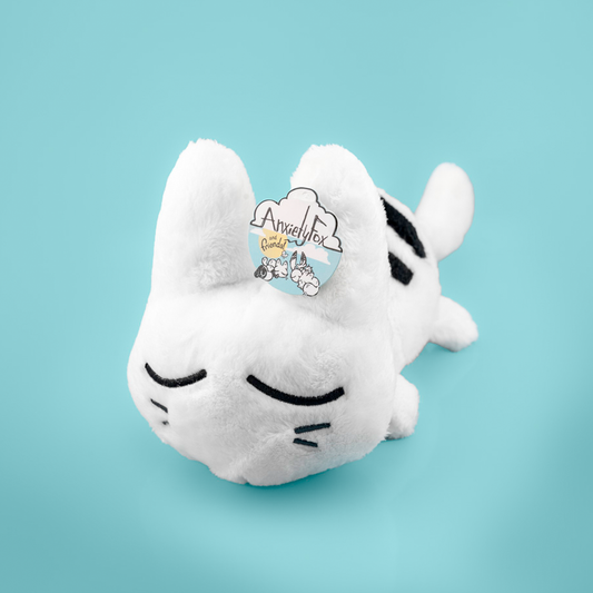 White plush cat toy with black accents on a light blue background