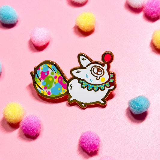 Gold enamel pin features Anxiety Fox as a clown, with screen printed details and a colorful tail!