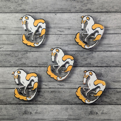 Five Borzoi dog pins with white bodies and orange accents on a wooden surface