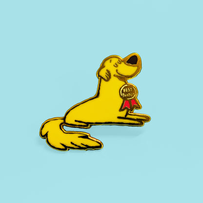 Yellow dog pin with a red ribbon on a light blue background