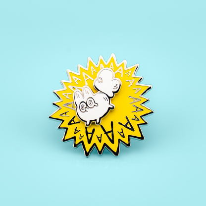 Enamel pin with a cartoon white fox and 'AA' text on a light blue background