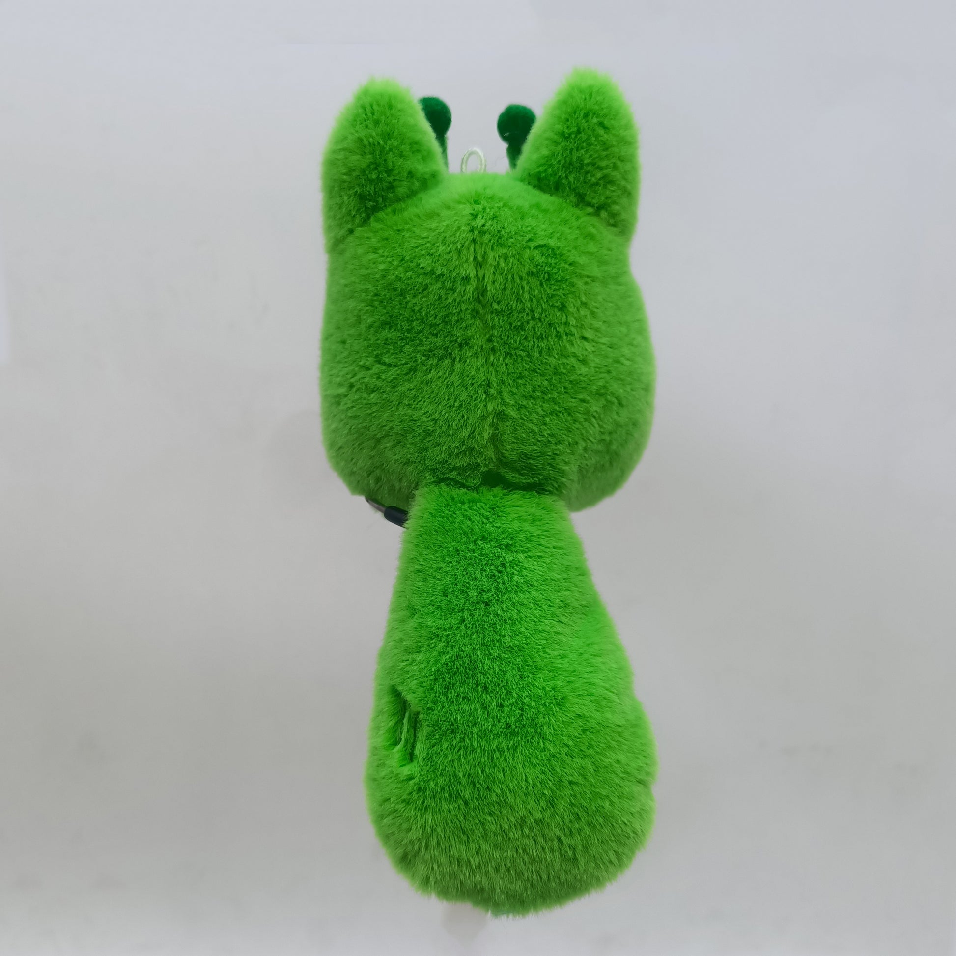 Back view of an alien fox plush toy