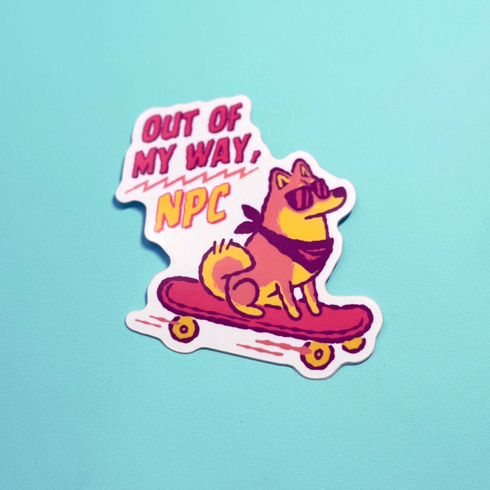 Sticker with a Shiba Inu dog on a skateboard and text 'Out of my way, NPC' on a light blue background