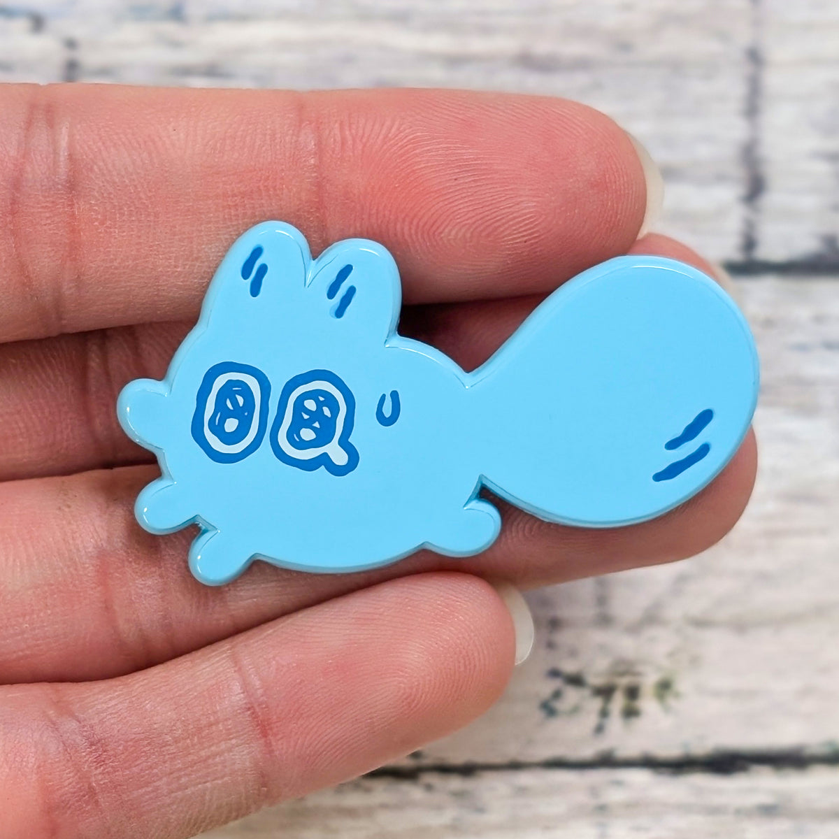 Enamel pin from Made By Nao! featuring a small, anxious face expressing feelings of worry and nervousness.