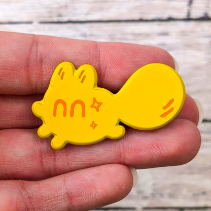 Colorful Smol Feelings enamel pin by Made By Nao! features a happy face design on a small, shiny metal pin.