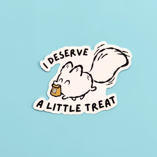 Cartoon white fox with a treat and text 'I DESERVE A LITTLE TREAT' on a light blue background