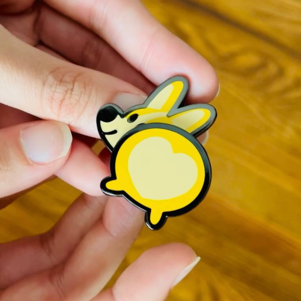 Bug the Corgi wiggle butt spring enamel pin by Made By Nao! Features a cute corgi with a playful, wiggling tail.
