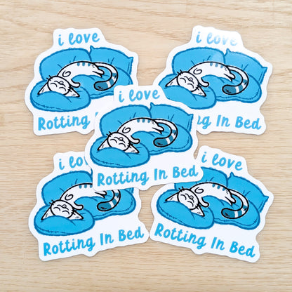 "Made By Nao! I Love Rotting in Bed Calming Kitty vinyl sticker featuring a cute cartoon kitty design"