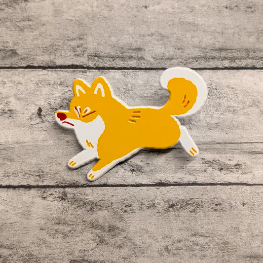 Shiba Inu enamel pin by Made By Nao! featuring a cute, detailed Shiba Inu dog design on a shiny metal pin.
