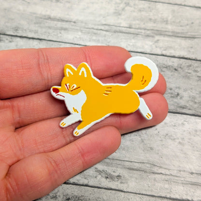 Shiba Inu enamel pin by Made By Nao! featuring a cute, detailed Shiba Inu dog design on a metal pin backing.
