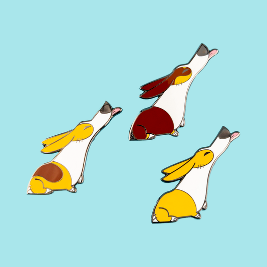 Enamel pin featuring a trio of Pembroke Welsh Corgis, made by Made By Nao! with detailed and colorful dog designs.