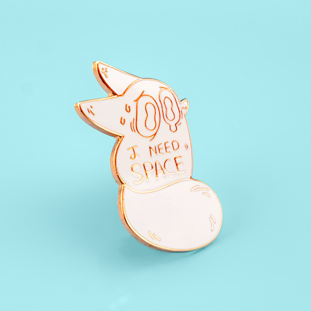 Gold enamel pin of an anxiety fox with space-themed design, made by Made By Nao!