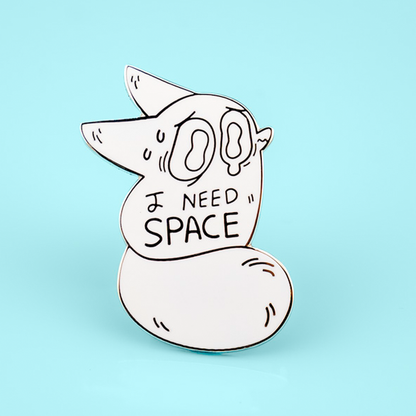 Close-up of the I Need Space Anxiety Fox enamel pin by Made By Nao! featuring a cute fox design on a space-themed background.