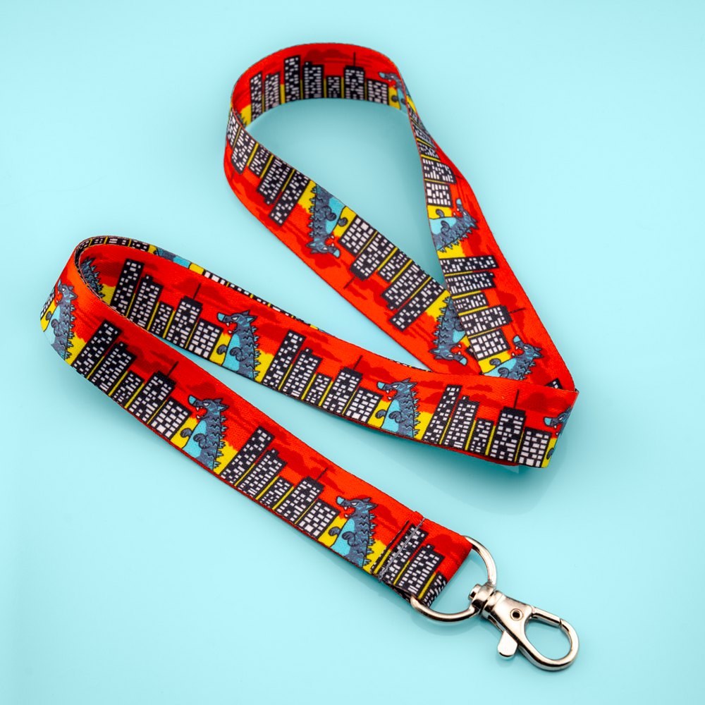 Kaiju Rampage lanyard by Made By Nao! featuring colorful monster design and sturdy clip for keys or ID badges.