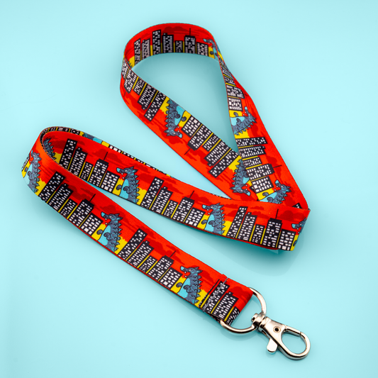 Kaiju Rampage lanyard by Made By Nao! featuring colorful monster design and sturdy clip for keys or ID badges.