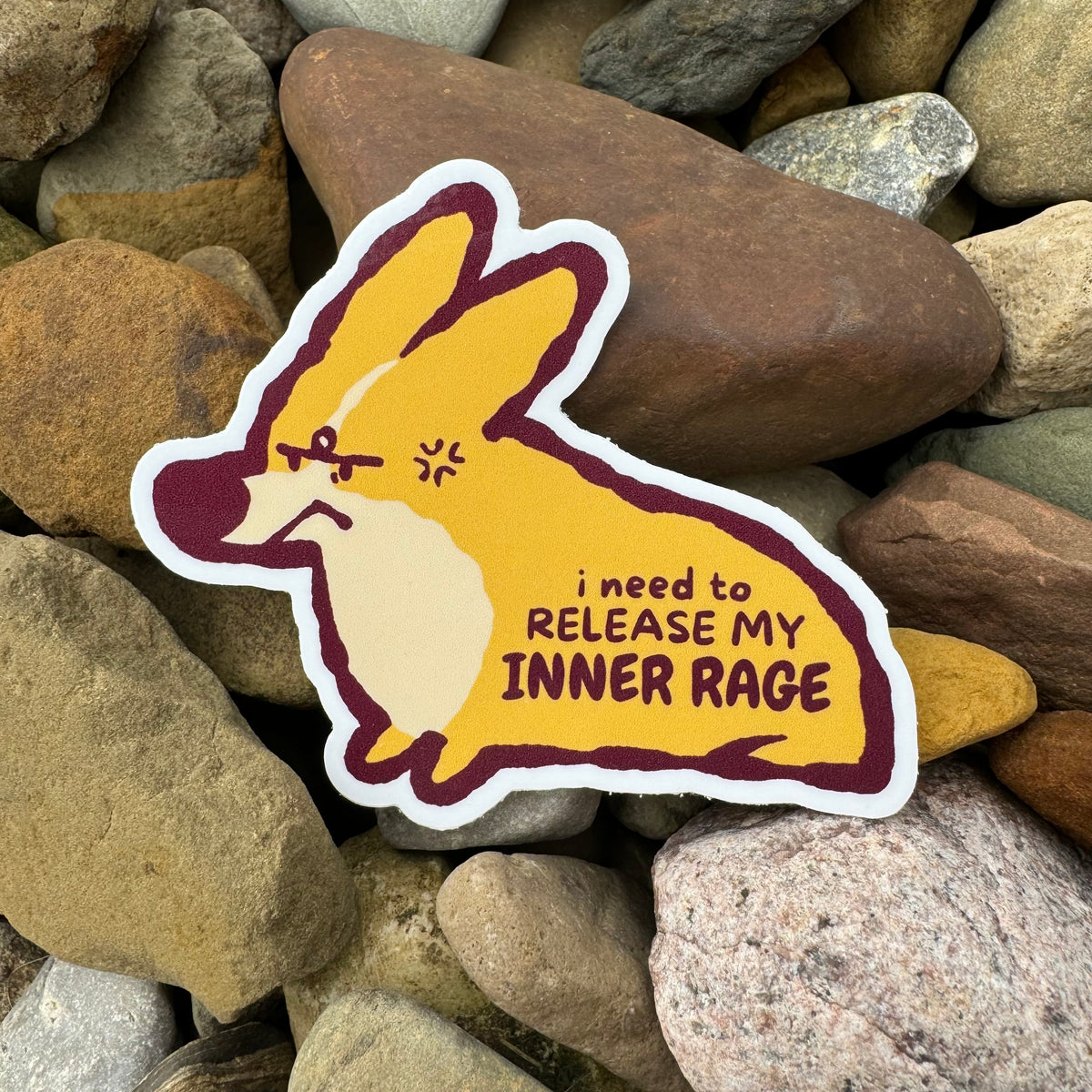 Vinyl sticker of Bug the Corgi from Made By Nao! with an expressive face, suitable for decorating laptops or water bottles.