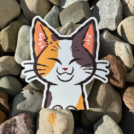 Weather-proof vinyl sticker featuring a cute calico cat peeker design, made by Nao! for outdoor and indoor decorating.