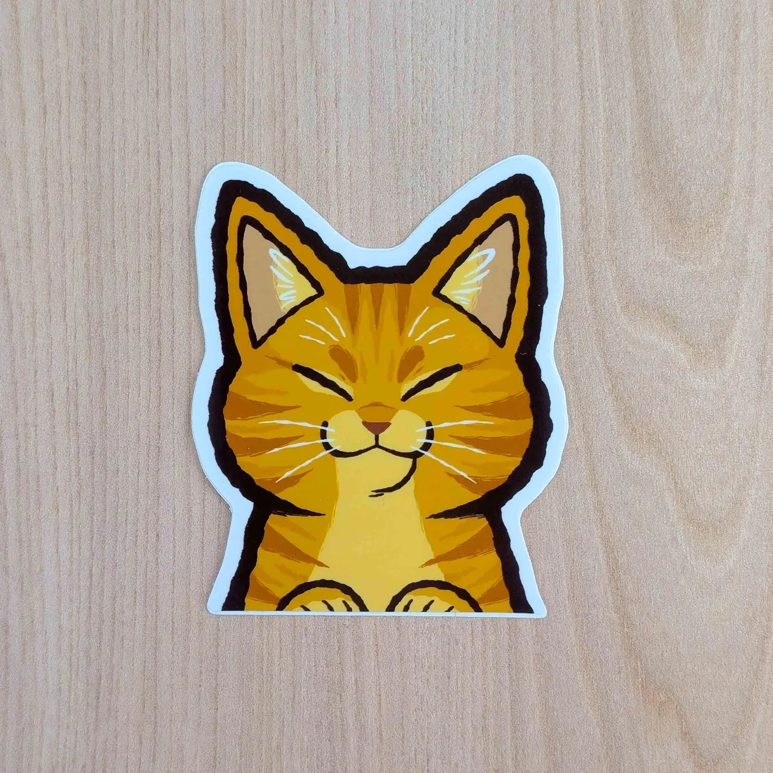 Orange Cat Peeker vinyl sticker by Made By Nao! featuring a cute feline peeking out, perfect for decorating laptops or notebooks.
