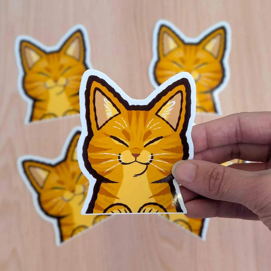 Orange Cat Peeker vinyl sticker by Made By Nao! featuring a cute cat peeking over the edge, perfect for decorating notebooks or laptops.