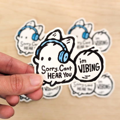 Vinyl sticker featuring a fox with text "Sorry, Can't Hear You, I'm Vibing" from Made By Nao! for anxiety awareness.