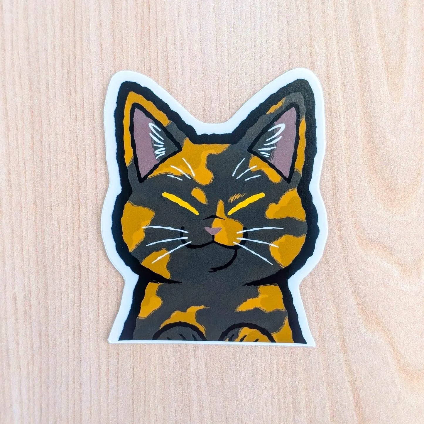 Tortoiseshell cat vinyl sticker by Made By Nao! featuring a cute peeker cat design on clear adhesive for decorating surfaces.