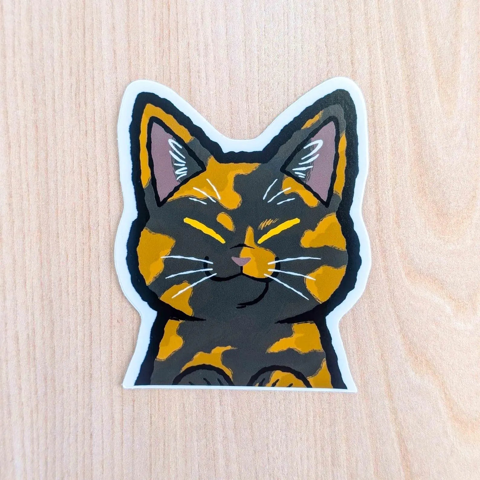 Tortoiseshell cat vinyl sticker by Made By Nao! featuring a cute peeker cat design on clear adhesive for decorating surfaces.