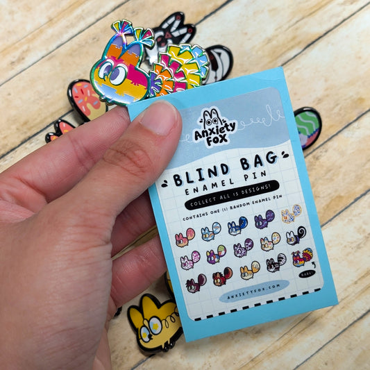 Group of Anxiety Fox Series 1 enamel pins by Naomi Romero Art, featuring colorful fox designs in a blind bag packaging.