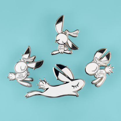 Support Bunny enamel pin by Naomi Romero Art, featuring a cute bunny design with the message "You Matter" in colorful enamel.