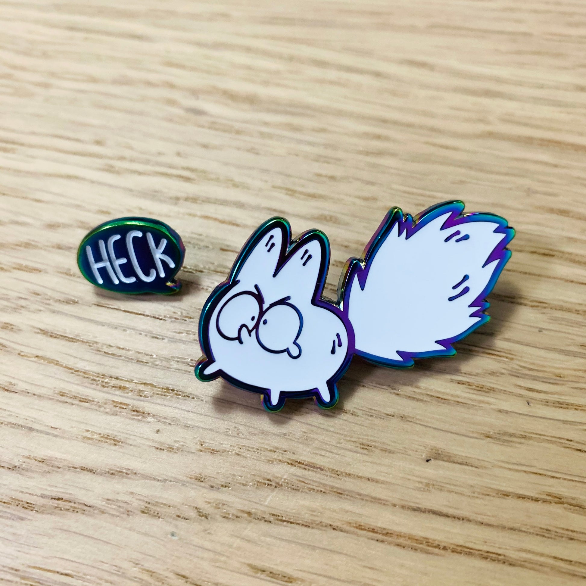 Colorful rainbow enamel pin featuring the Anxiety Fox design from Made By Nao! in the Heck! Deluxe Enamel Pin Set.